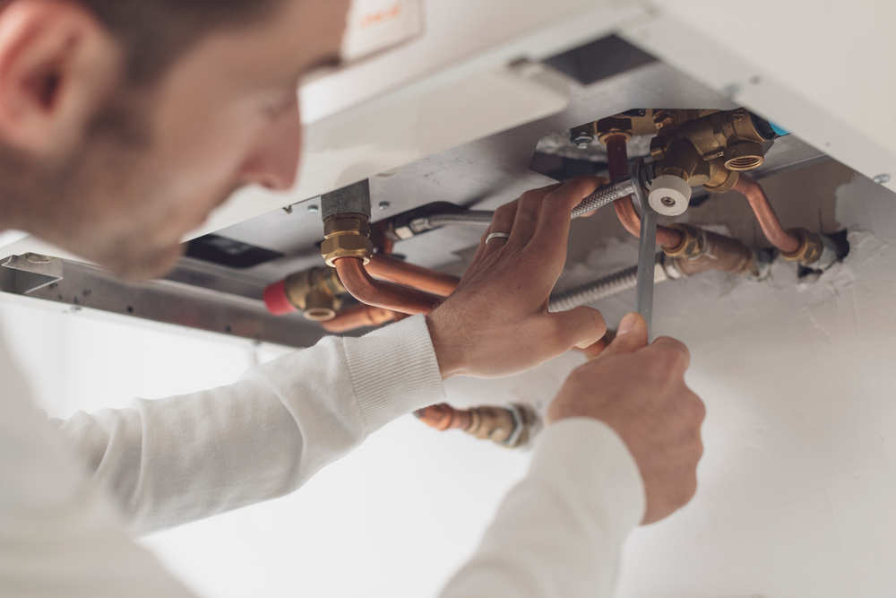 An electrician fitting a light bulb
